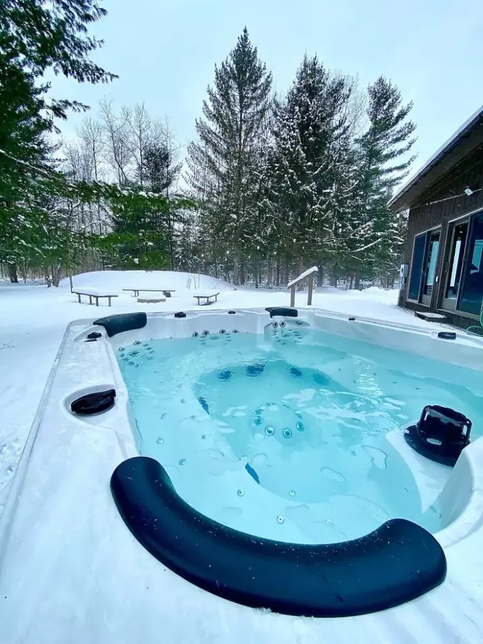 The same hot tub and string lights in the original daytime listing photo