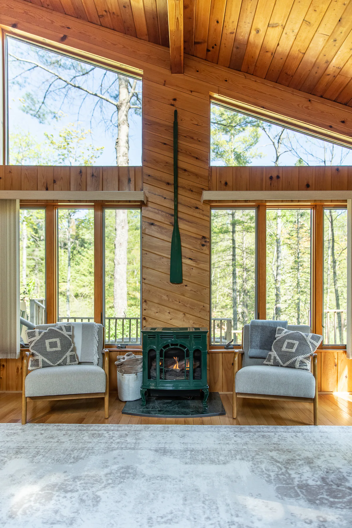 Serenity A-Frame fireplace seating area with two fictional adult guests added for a lifestyle concept source photo